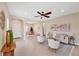 Open living space featuring neutral walls, tile flooring, ceiling fan, and a seamless flow to other rooms at 11455 Fort Lauderdale Pl, Venice, FL 34293