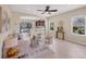 Stylish living room with neutral decor, large windows, open layout, and a view of the screened in pool area at 11455 Fort Lauderdale Pl, Venice, FL 34293