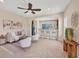 Open-concept living room with a ceiling fan, comfortable seating, and views into the kitchen area at 11455 Fort Lauderdale Pl, Venice, FL 34293
