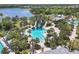 Aerial shot of a resort-style pool featuring a water slide surrounded by lush tropical landscaping at 11455 Fort Lauderdale Pl, Venice, FL 34293
