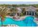 Resort-style pool with a lounge area, a modern clubhouse, palm trees, and a luxurious black and white tile area at 11455 Fort Lauderdale Pl, Venice, FL 34293