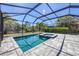 Screened in pool and spa with lush greenery behind it at 11455 Fort Lauderdale Pl, Venice, FL 34293