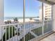 Scenic balcony view showcasing the beach, pool, and surrounding landscape with a protective screened railing at 1150 Tarpon Center Dr # 3G 307, Venice, FL 34285
