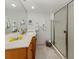 Well-lit bathroom features a modern vanity, a framed mirror, and a glass-enclosed shower at 1150 Tarpon Center Dr # 3G 307, Venice, FL 34285