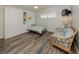 Comfortable bedroom with a murphy bed, a lounge sofa, and wood-style flooring at 1150 Tarpon Center Dr # 3G 307, Venice, FL 34285
