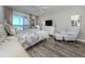 Cozy bedroom with a queen bed, a ceiling fan, and access to an ocean-view balcony at 1150 Tarpon Center Dr # 3G 307, Venice, FL 34285