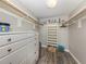 Organized closet featuring built-in shelving, ample storage, and light wood floors at 1150 Tarpon Center Dr # 3G 307, Venice, FL 34285
