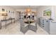 Cozy dining area with seating for four, view to the kitchen, and elegant decor at 1150 Tarpon Center Dr # 3G 307, Venice, FL 34285