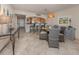Bright dining area with seating for four, view to the kitchen, and neutral decor at 1150 Tarpon Center Dr # 3G 307, Venice, FL 34285