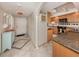 Inviting kitchen featuring granite countertops, wooden cabinets, stainless steel appliances, and tile flooring at 1150 Tarpon Center Dr # 3G 307, Venice, FL 34285