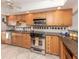 Well-equipped kitchen featuring stainless steel appliances and wooden cabinetry at 1150 Tarpon Center Dr # 3G 307, Venice, FL 34285
