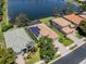 Aerial view of house with solar panels and large lake at 11610 Dancing River Dr, Venice, FL 34292
