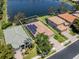Aerial view of backyard of house featuring screened in pool and lake at 11610 Dancing River Dr, Venice, FL 34292