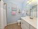 Bathroom featuring a shower and vanity with pink beach-themed decor and refreshing, light blue paint at 11610 Dancing River Dr, Venice, FL 34292