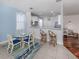 Charming dining area features a glass table, stylish chairs, and seamless access to the kitchen at 11610 Dancing River Dr, Venice, FL 34292