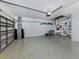 View of a clean garage with epoxy flooring offering ample storage space at 11610 Dancing River Dr, Venice, FL 34292