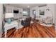 Open-concept living area with views to other rooms, hardwood floors and stylish lighting at 11610 Dancing River Dr, Venice, FL 34292