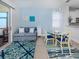 Cozy living room with a comfortable sofa, elegant chandelier, and seamless access to outdoor balcony at 11610 Dancing River Dr, Venice, FL 34292