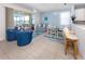 Bright living room with sliding glass doors leading to a screened patio with tranquil lake views at 11610 Dancing River Dr, Venice, FL 34292