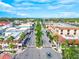 Aerial view of a charming street featuring mature trees and quaint buildings in a desirable community at 11711 Alessandro Ln, Venice, FL 34293