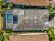 Aerial view of home featuring a screened-in pool and a well-maintained roof at 11711 Alessandro Ln, Venice, FL 34293