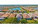 Community aerial view featuring lake, lush landscaping, and tile roofs at 11711 Alessandro Ln, Venice, FL 34293