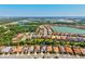 Wide aerial shot of homes in a community with a lake in the background at 11711 Alessandro Ln, Venice, FL 34293