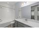Bathroom featuring white subway tile, a shower-tub combination, and a sleek vanity with modern fixtures at 11711 Alessandro Ln, Venice, FL 34293