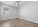 Well-lit bedroom with tile floors and a large window with blinds providing natural light and privacy at 11711 Alessandro Ln, Venice, FL 34293
