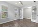 Bedroom featuring wood-look tile flooring, neutral walls, and bright natural light at 11711 Alessandro Ln, Venice, FL 34293