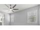 Light-filled bedroom with two windows, neutral paint, and a view of the outside at 11711 Alessandro Ln, Venice, FL 34293