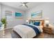 Inviting bedroom featuring beach-themed decor, natural accents, and a ceiling fan for added comfort at 11711 Alessandro Ln, Venice, FL 34293