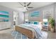 Staged primary bedroom featuring soft blue accents, natural light, and en suite bathroom at 11711 Alessandro Ln, Venice, FL 34293