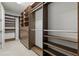 Walk-in closet with custom built-in shelving and drawers providing ample storage space at 11711 Alessandro Ln, Venice, FL 34293