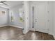 Bright entryway with wood-look tile, featuring a glass-accented front door and natural light at 11711 Alessandro Ln, Venice, FL 34293