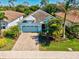 Well-maintained home with a two-car garage, paver driveway, and manicured lawn at 11711 Alessandro Ln, Venice, FL 34293