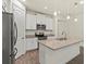 Bright kitchen with white cabinetry, stainless appliances, and granite countertops at 11711 Alessandro Ln, Venice, FL 34293