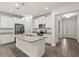 Full view of kitchen showing granite countertops, stainless steel appliances, and wood floors at 11711 Alessandro Ln, Venice, FL 34293