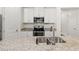 Close-up of a kitchen featuring granite countertops, and stainless steel appliances at 11711 Alessandro Ln, Venice, FL 34293
