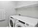Laundry room featuring a side-by-side washer and dryer, providing convenience for everyday living at 11711 Alessandro Ln, Venice, FL 34293