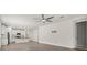 Open-concept kitchen and living room with tile floors, stainless appliances, and breakfast bar at 11711 Alessandro Ln, Venice, FL 34293