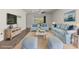 Living room featuring wood floors, light blue seating, and view of the outdoor area at 11711 Alessandro Ln, Venice, FL 34293