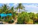 Beautiful pier view through palm trees and lush landscaping near the beach at 11711 Alessandro Ln, Venice, FL 34293