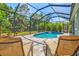 Secluded pool area with covered enclosure and lounge chairs for relaxation at 11711 Alessandro Ln, Venice, FL 34293