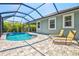 Private pool with waterfall feature surrounded by lush landscaping at 11711 Alessandro Ln, Venice, FL 34293