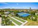 Aerial view of tennis courts and bocce ball with lush tropical landscaping in the community at 11711 Alessandro Ln, Venice, FL 34293