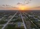 Community aerial shot during sunset highlighting nearby roads and houses at 12199 Xavier Ave, Port Charlotte, FL 33981