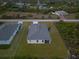 Aerial view of the home showcasing the backyard, play set and roof at 12199 Xavier Ave, Port Charlotte, FL 33981