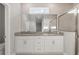 Luxurious en suite bathroom with dual vanity, granite countertop, and glass shower at 12199 Xavier Ave, Port Charlotte, FL 33981