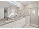 Bright bathroom featuring a dual vanity with granite countertop and a glass shower at 12199 Xavier Ave, Port Charlotte, FL 33981